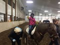 A student rides a horse at Fieldstone Farm.