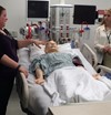 Students learn about patient care using simulators.