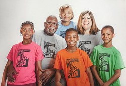Ashlei, grandfather, three siblings and Sarah Adair in group photo wearing Never Give Up t-shirts