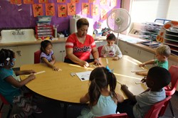Pre-K students working with teacher