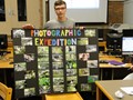 Student with photography poster