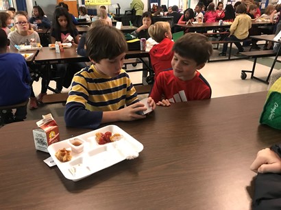 Two students talking at table