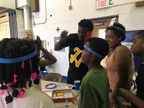 Kids wearing headbands playing game in school gym