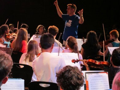 Conductor and musicians playing