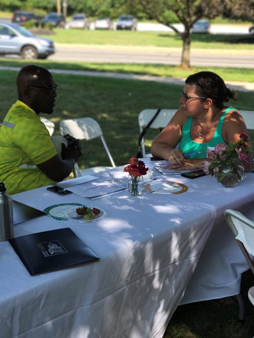 People talking at table in park