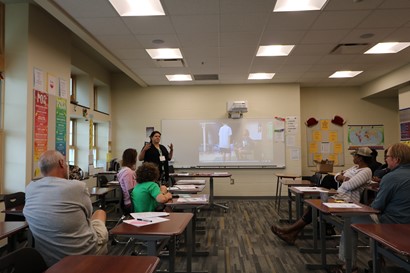 Instructor with class attendees in classroom