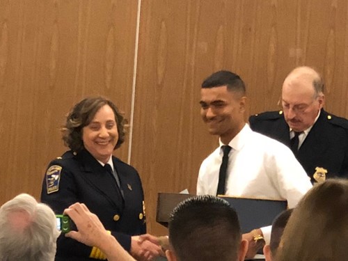 Travis receiving diploma from police chief