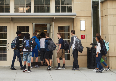 students walking into high school