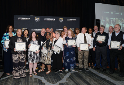 group smiling with plaques