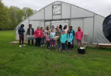 kids in front of greenhouse