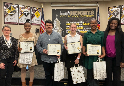 four students with superintendent and board president