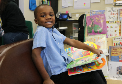 boy smiling with book