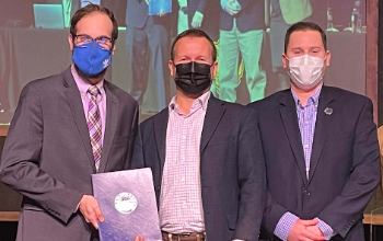 people standing on stage holding certificates