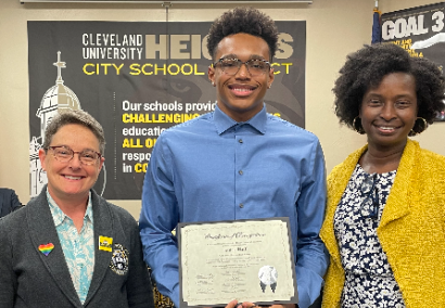 student with certificate and two adults