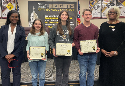 three students holding certificates