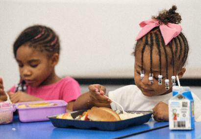 young child eating lunch