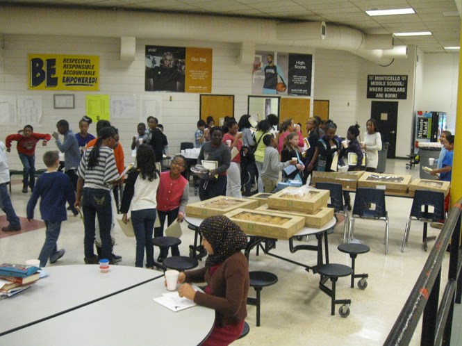 Awardees being treated with doughnuts and juice