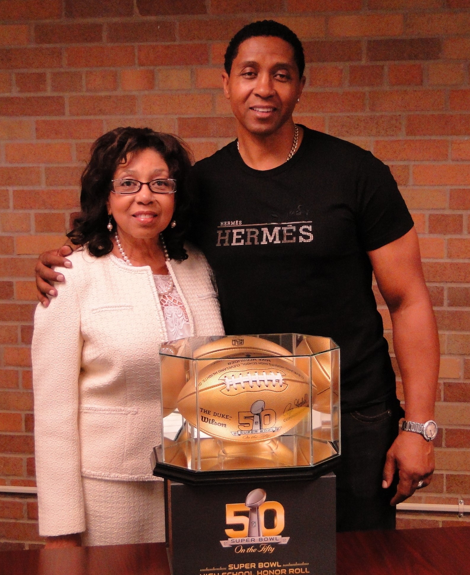 Mike McGruder and his mother, Marian Wallace, retired Glenville principal..