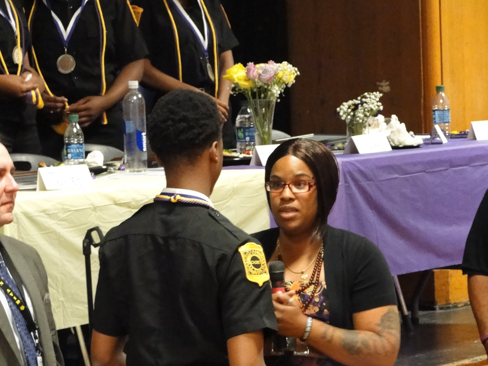 Ms. Raheem talks to an award reciepient.