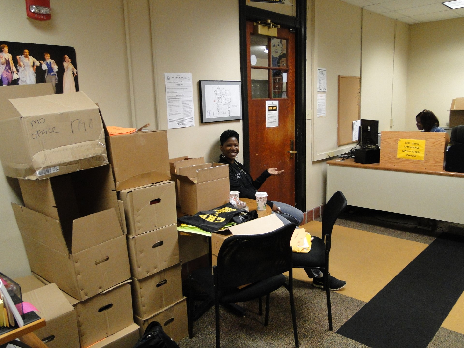 Faith Gordon among the many boxes in the Mosaic office.