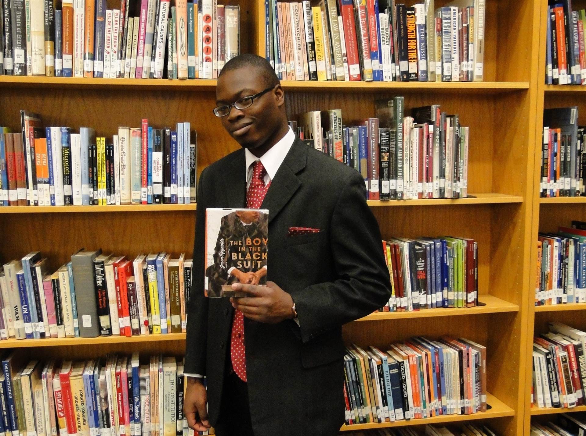 Darwin Scott with the book &#39;The Boy in the Black Suit.&#39;