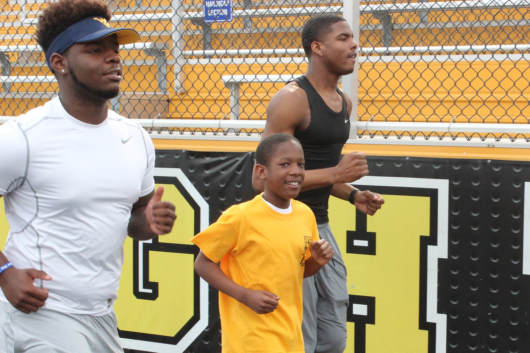 Boulevard student and Special Olympian Jayson Mosley training with Heights High juniors Kenneth Roye’ Jr. (left) and Jaylen Harris.