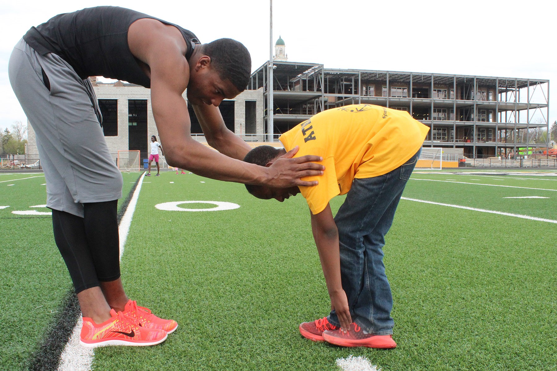 Boulevard student and Special Olympian Jayson Mosley stretching with Heights High junior Jaylen Harris.