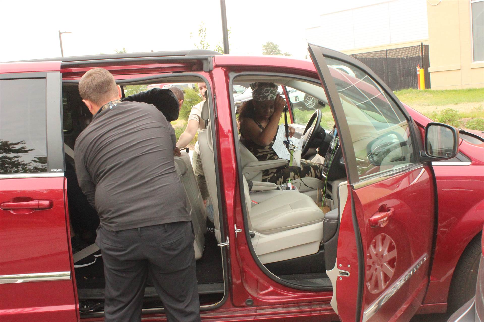 Visit the parking lot, photo of team in a members car.