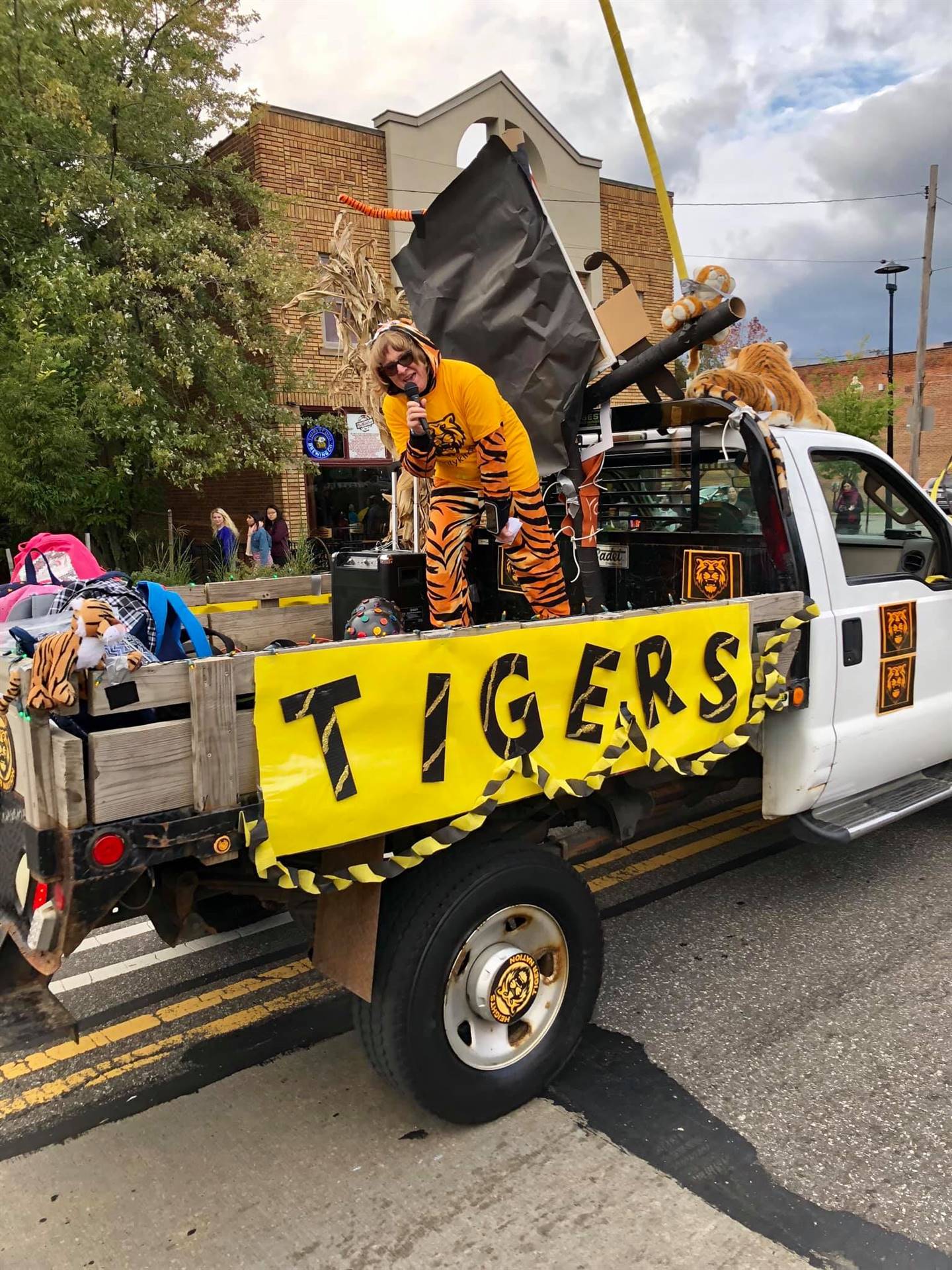 Woman on back of truck singing into microphone