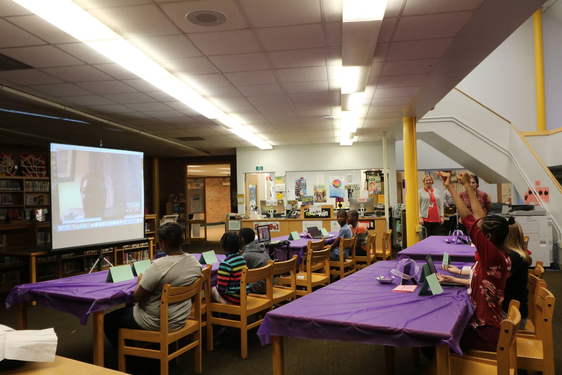 Students sitting in media center watching Skype video