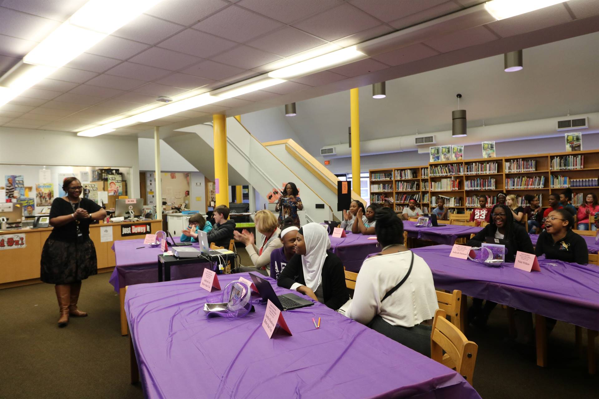 Students sitting at tables discussing quiz questions