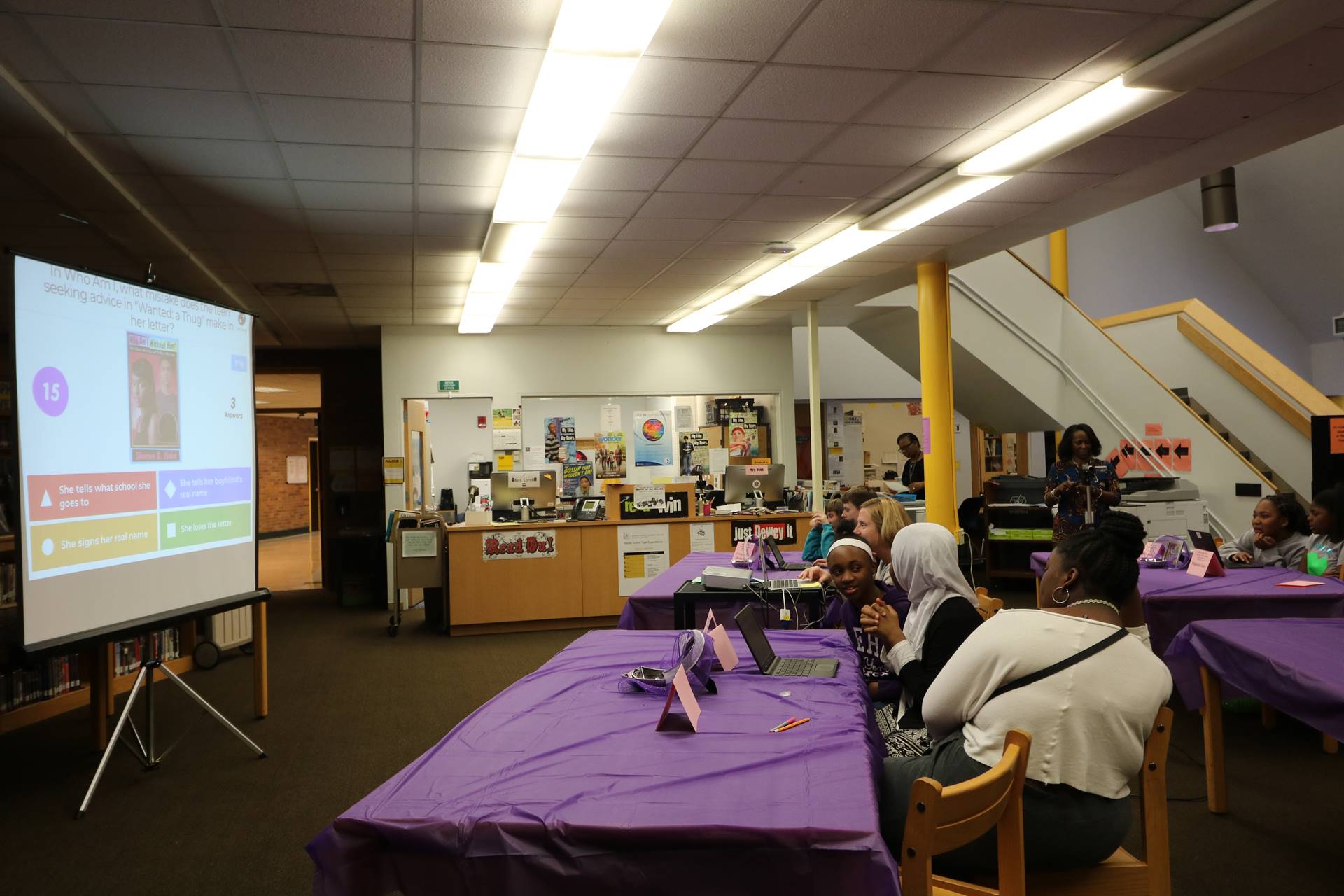 Students sitting at tables discussing quiz questions