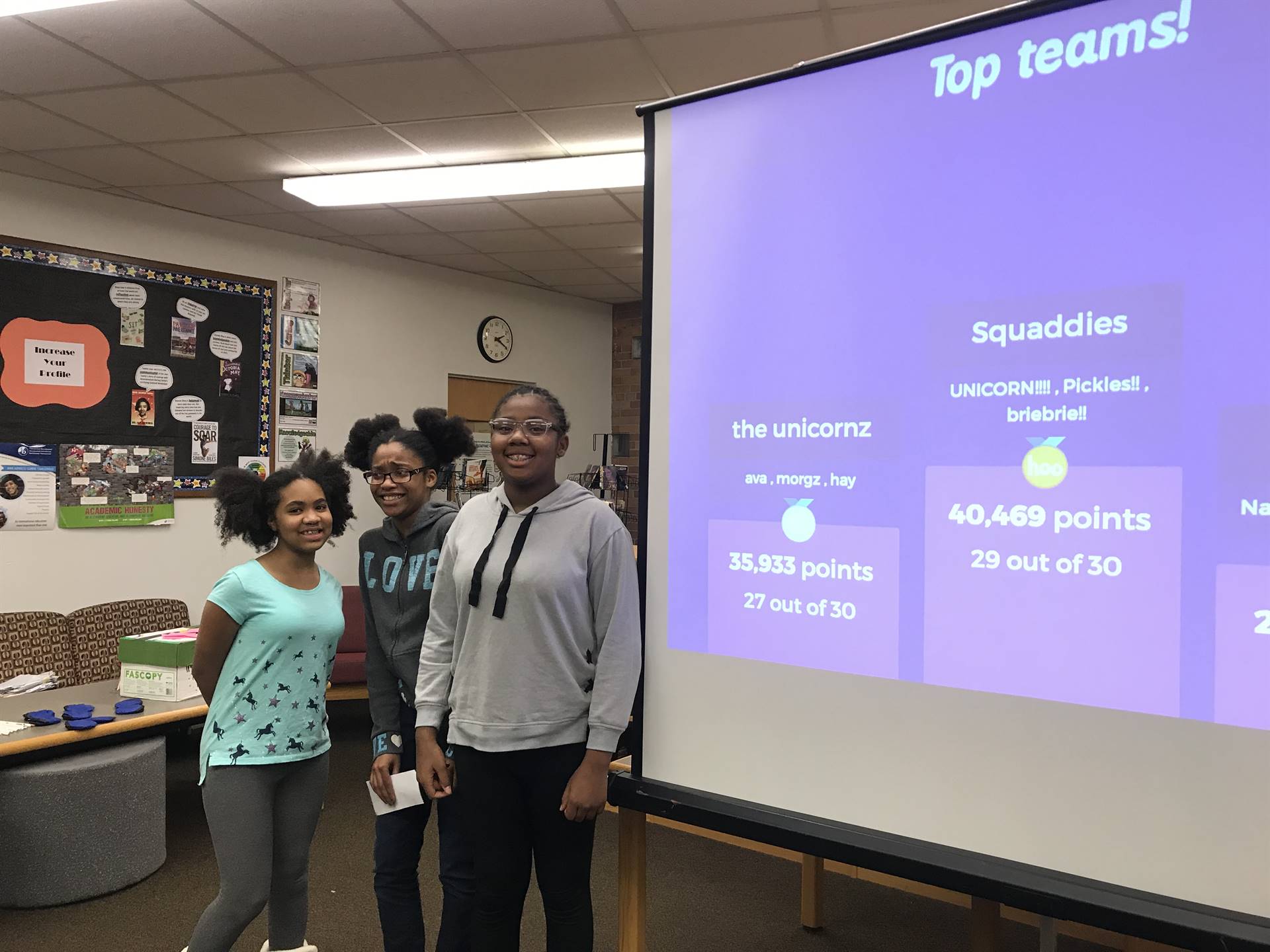 Three students by screen