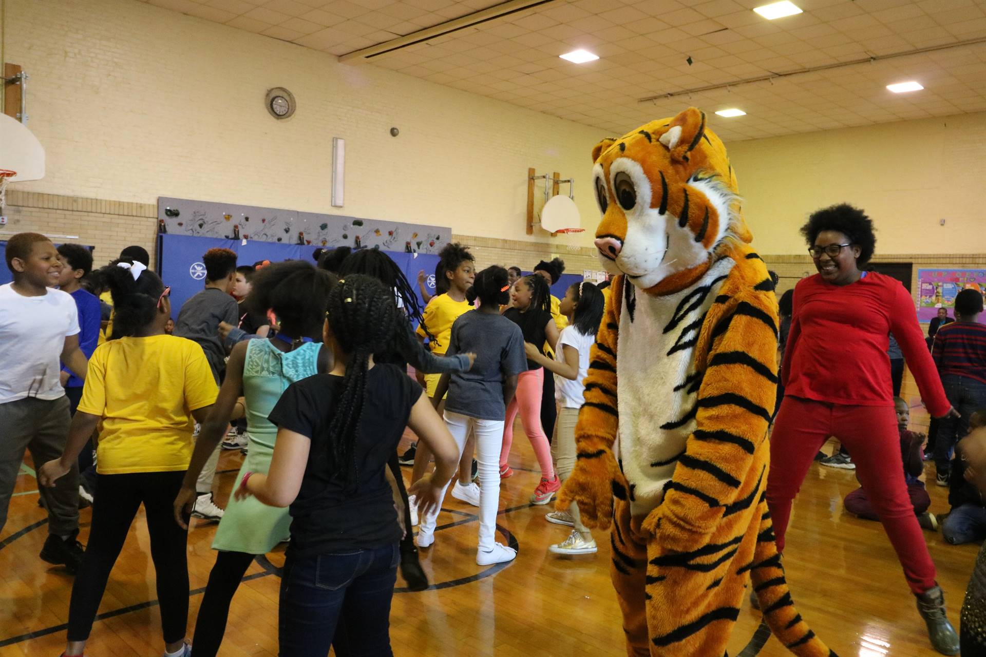 TJ the Tiger dances with students