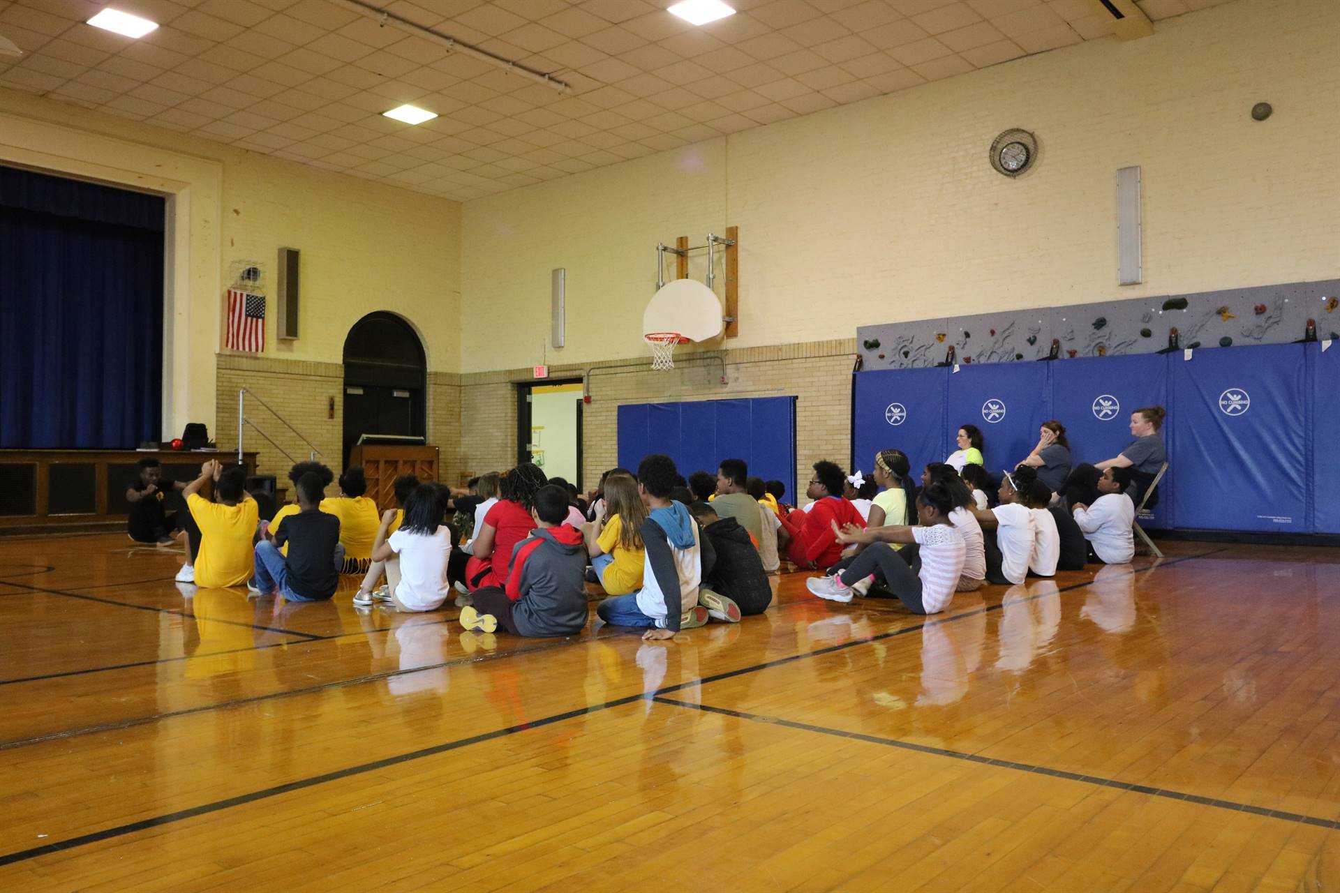 Kids do sitting workout in gym