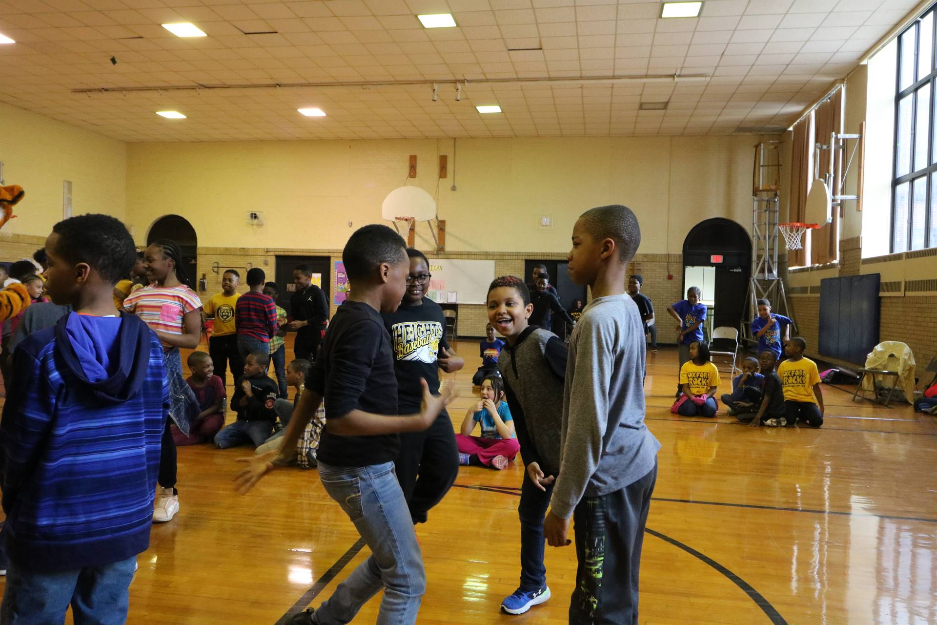 Four male students dancing