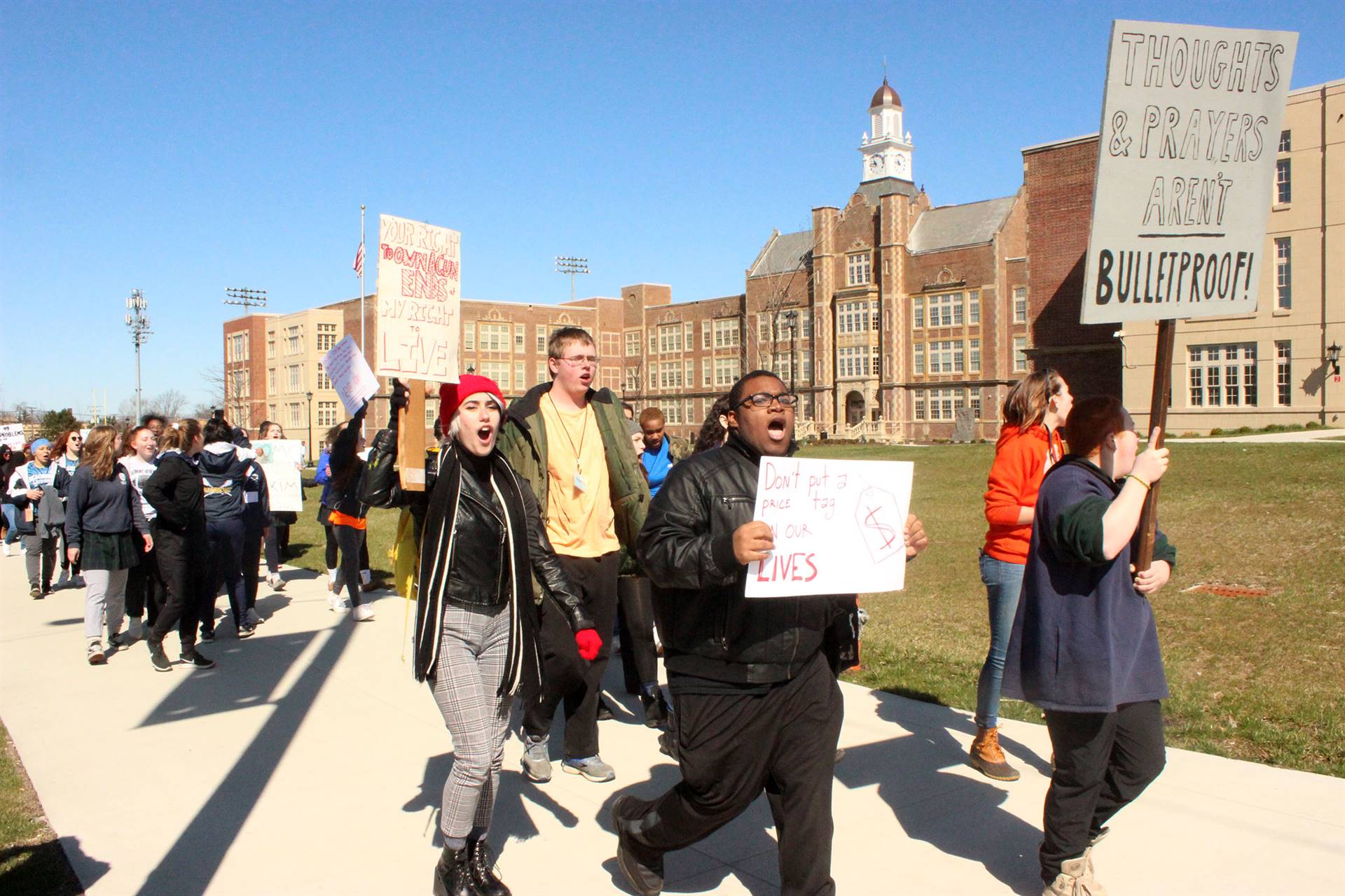 Heights High students march in front of the school