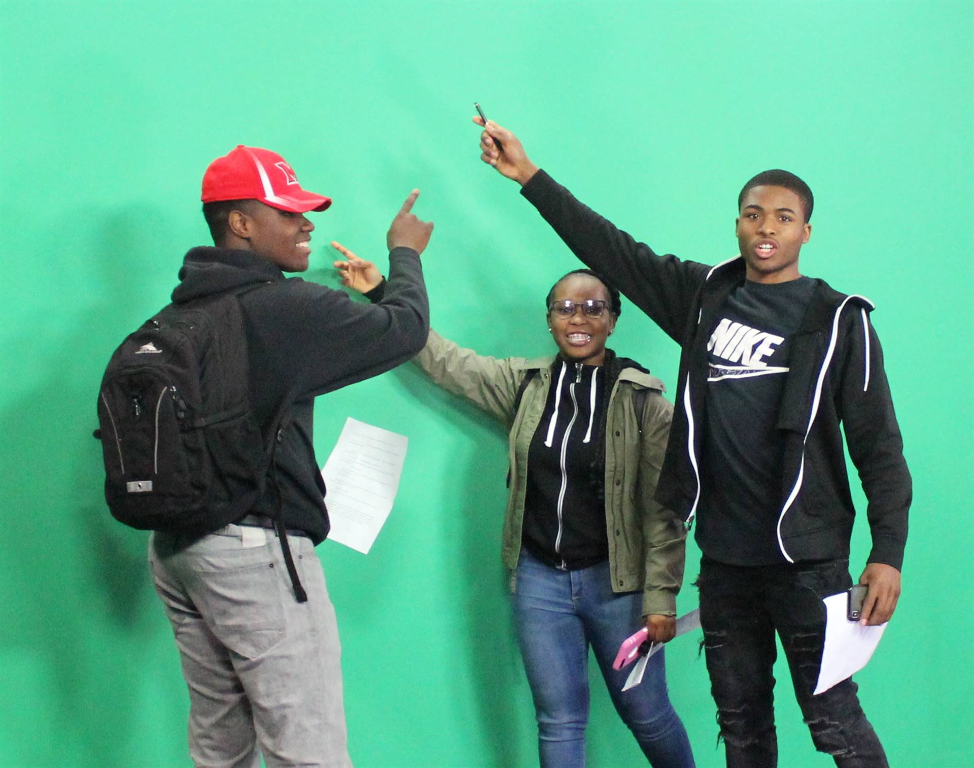 Students practice using the green screen.