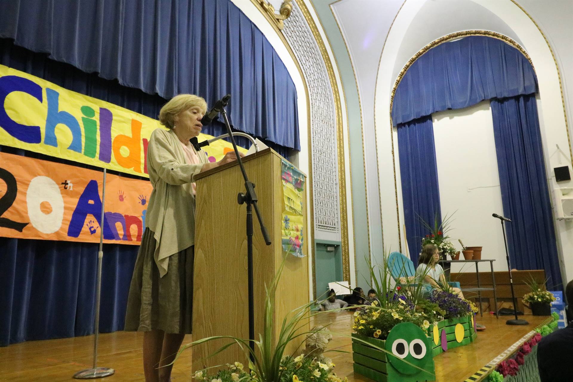 Female reader at podium with student sitting