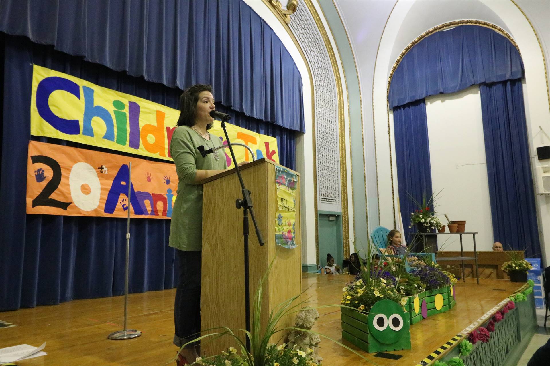 Female reader at podium with student sitting