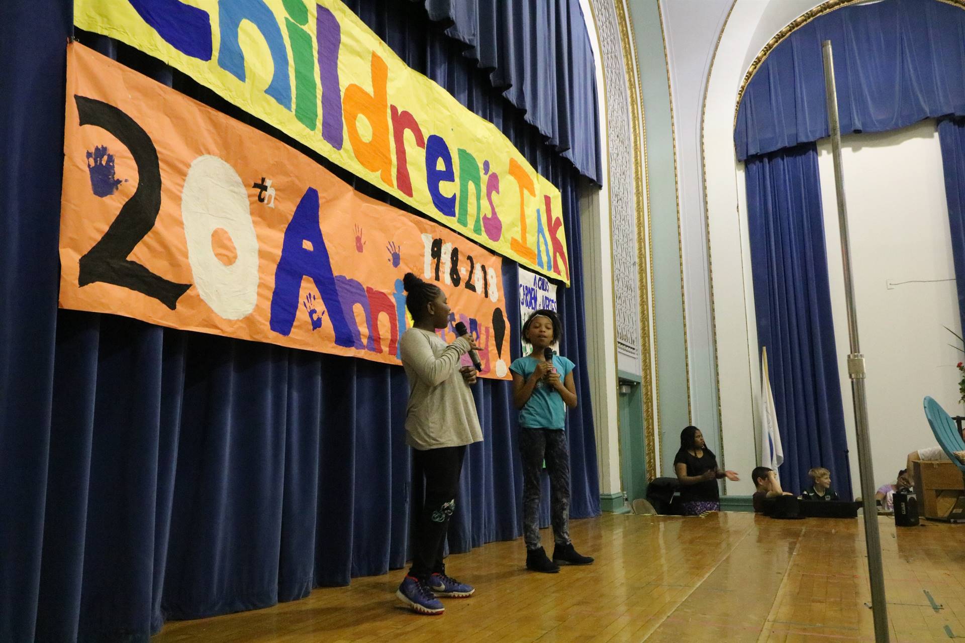 Two female students singing on stage