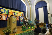 Female teachers on stage hugging