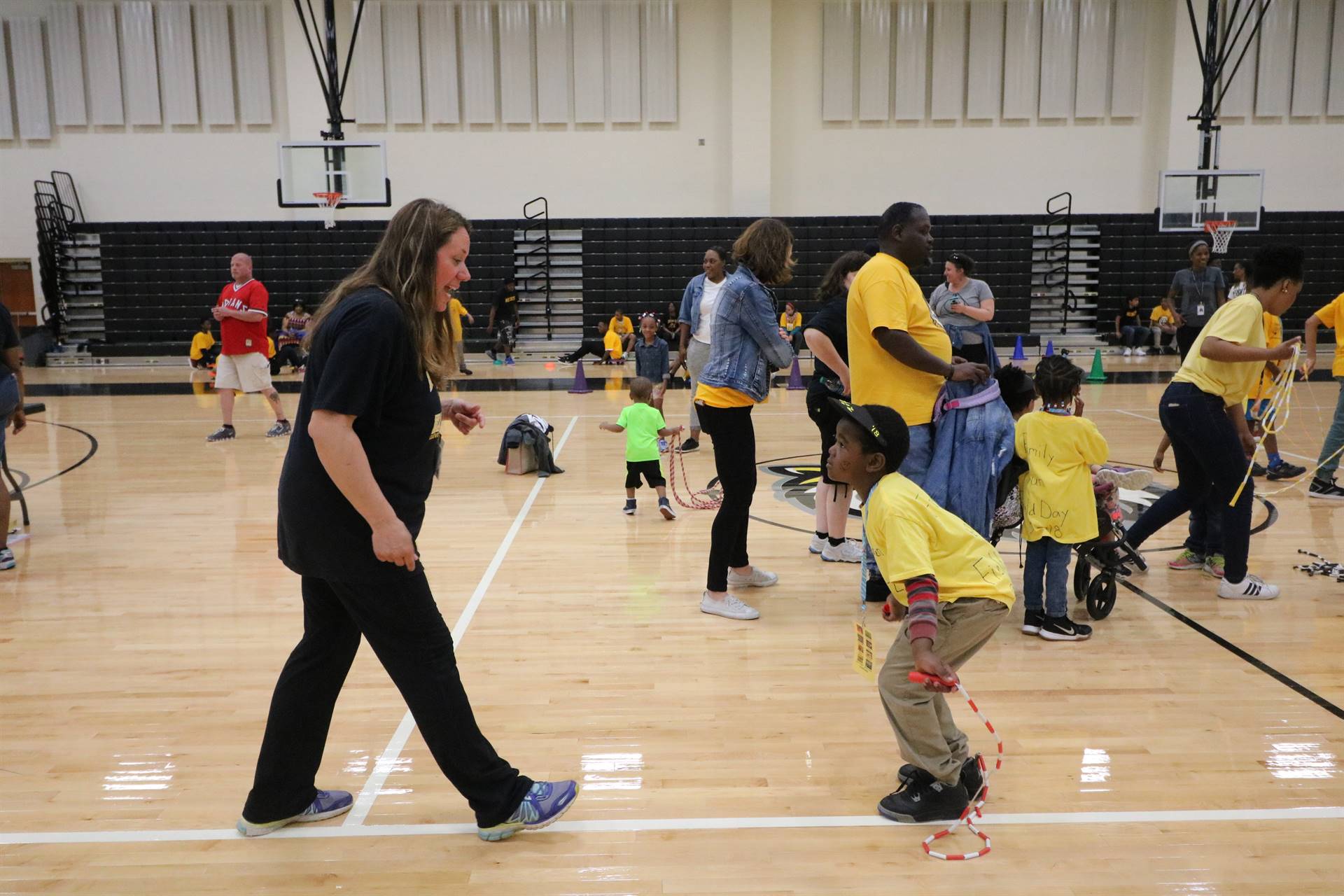 Adult showing child how to jump rope