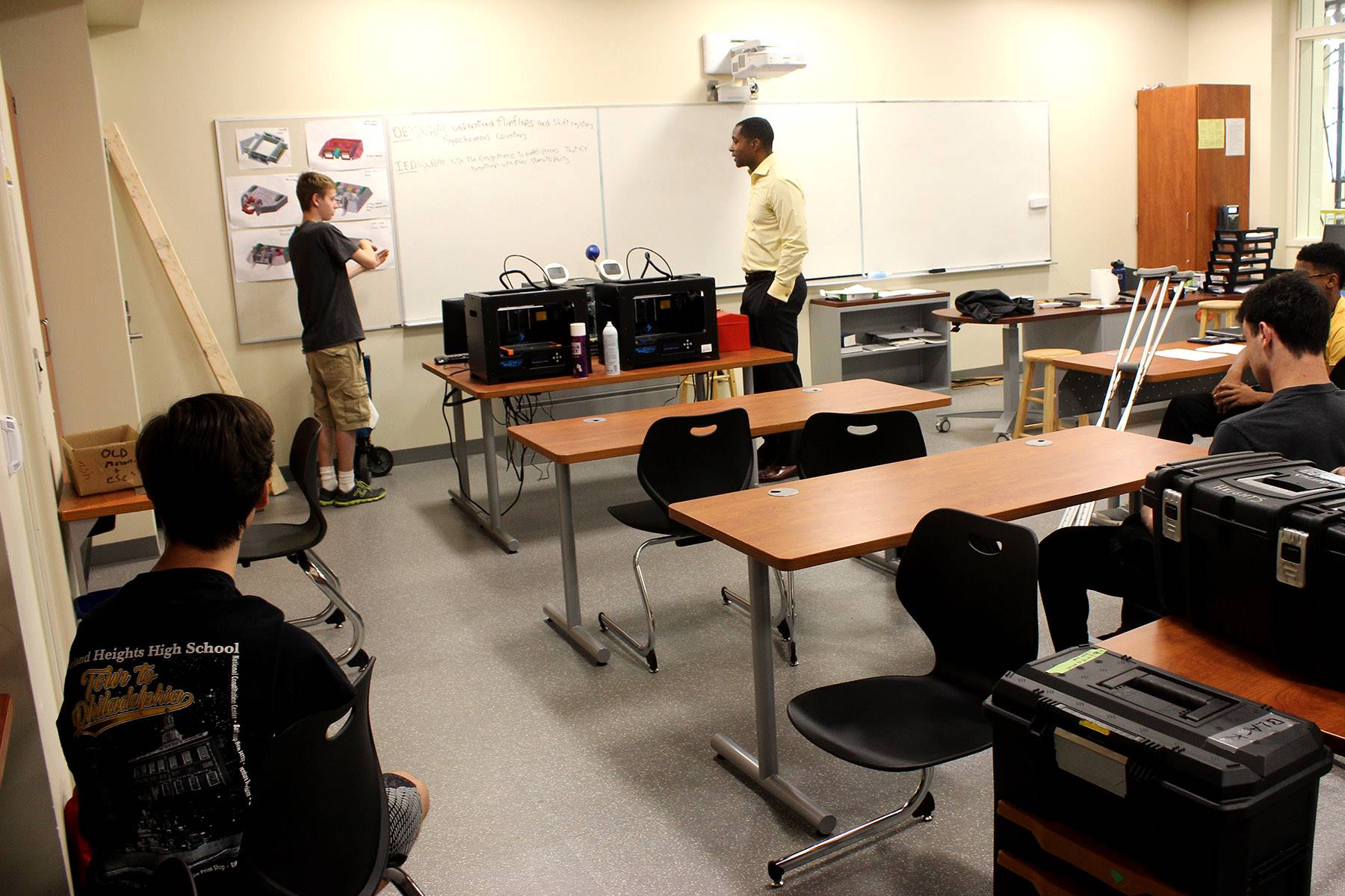 Milton "Chip" Morris listens to a Heights High Robotics student