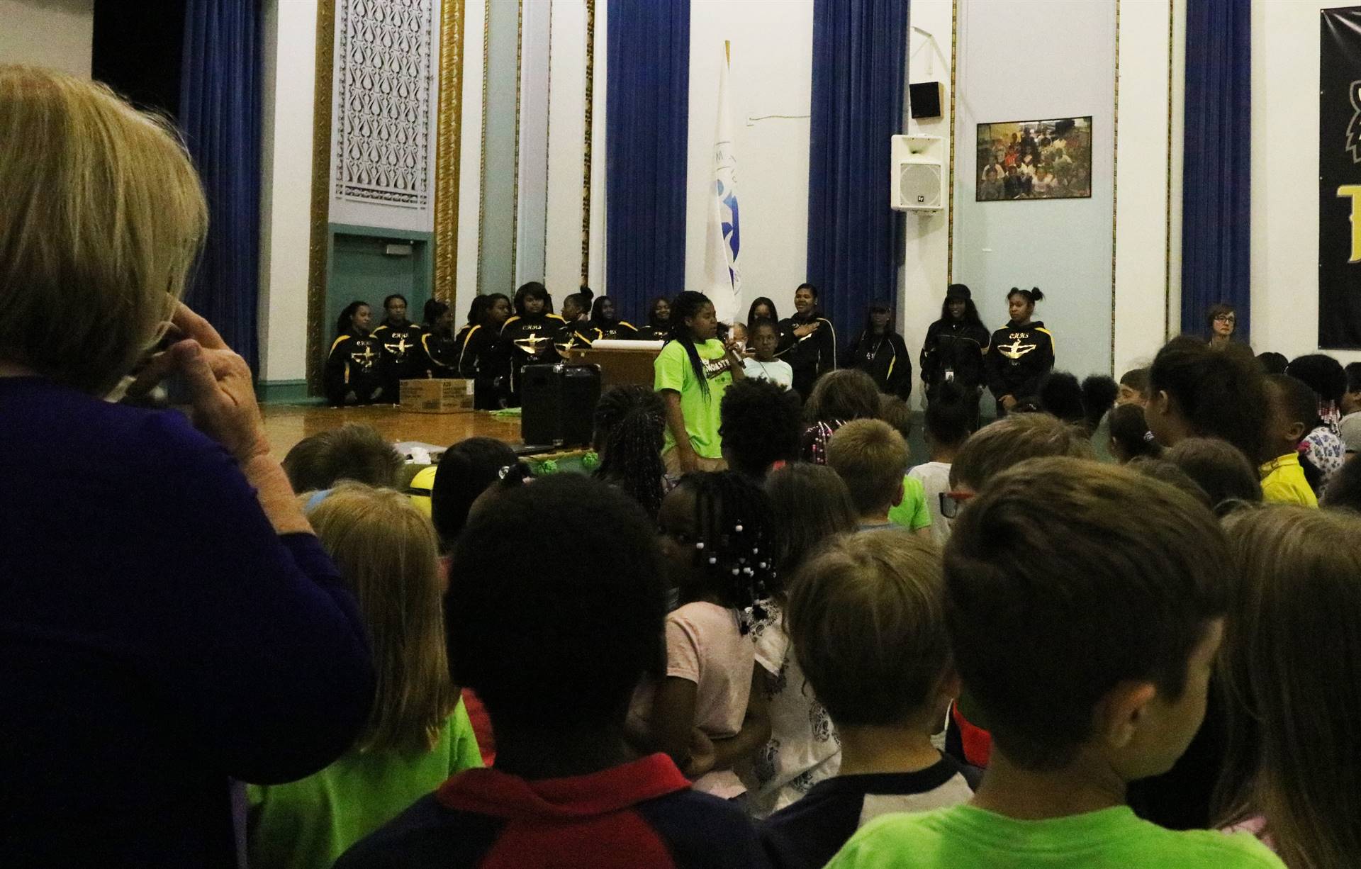 Female student singing national anthem