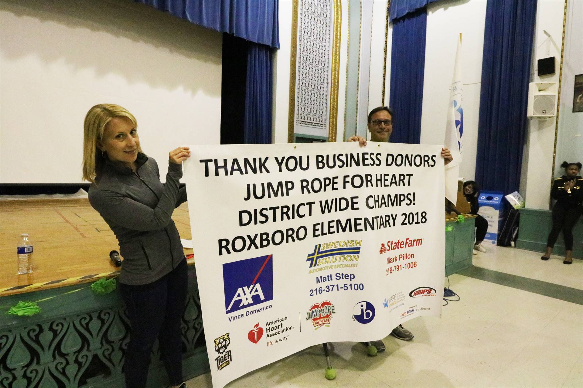 Clare Taft and Vince Nemeth holding thank you banner