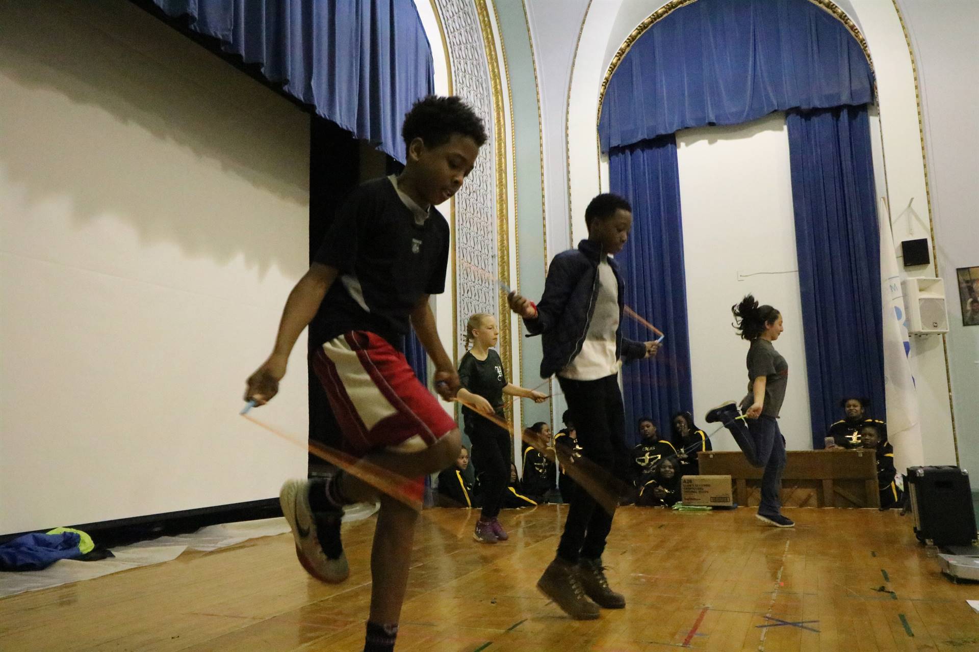 Students on stage jumping rope