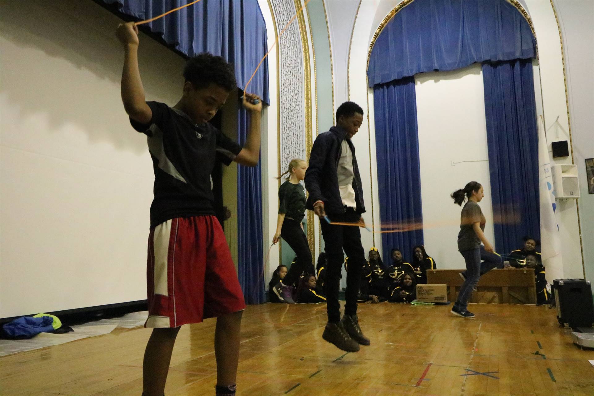 Students on stage jumping rope