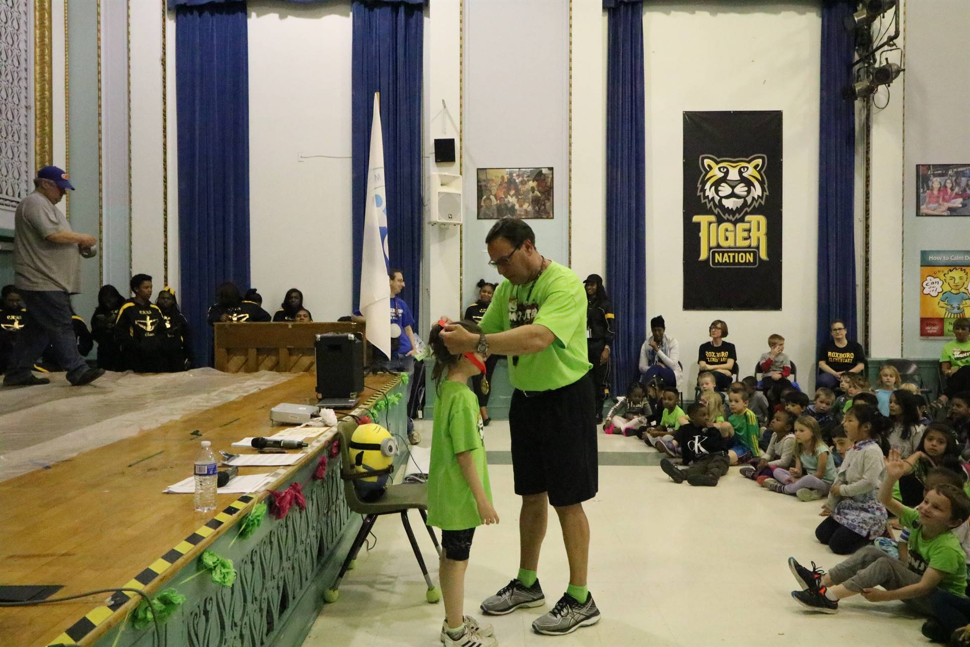 Vince Nemeth putting medal around girl's neck