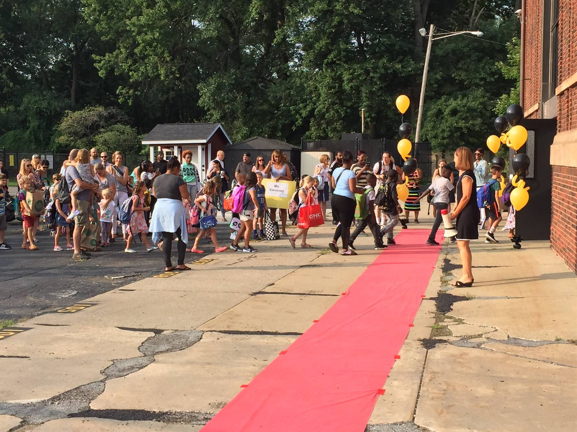 Students walking red carpet into school